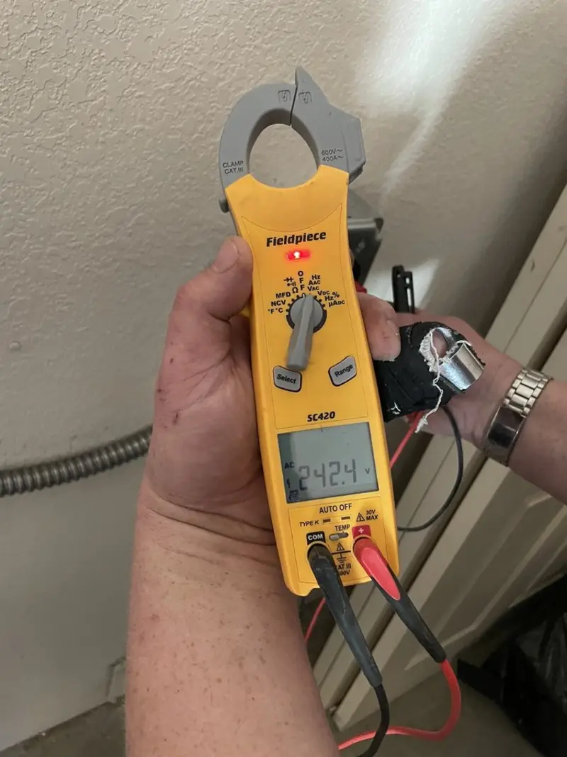 Voltage testing with clamp meter during Whole House Surge Protector in Massapequa Park